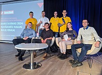 A group photo from the "Investuok" event, participants posing in front of a slide titled "Investing 2024: Preparing for a New Bull Market."