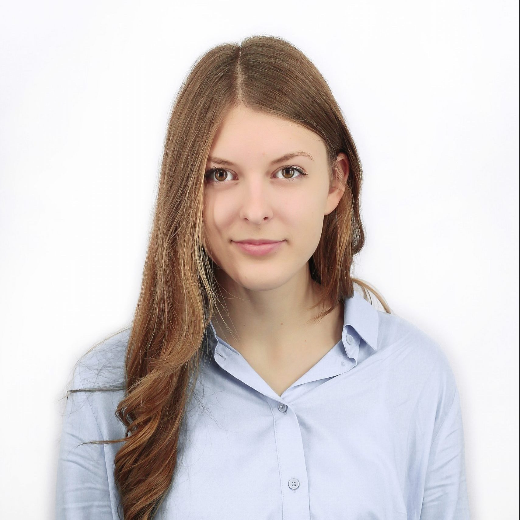 Student with long brown hair in a light blue shirt.