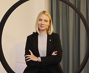 A woman smiling sitting on the office swing